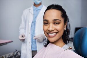 smiling dental patient with the dentist in the background